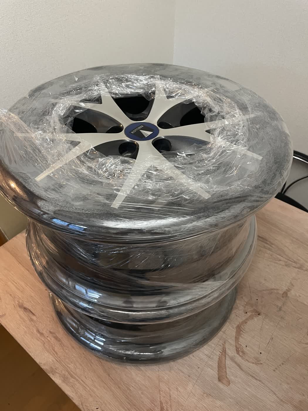Wheels with the tires removed, wrapped and stacked