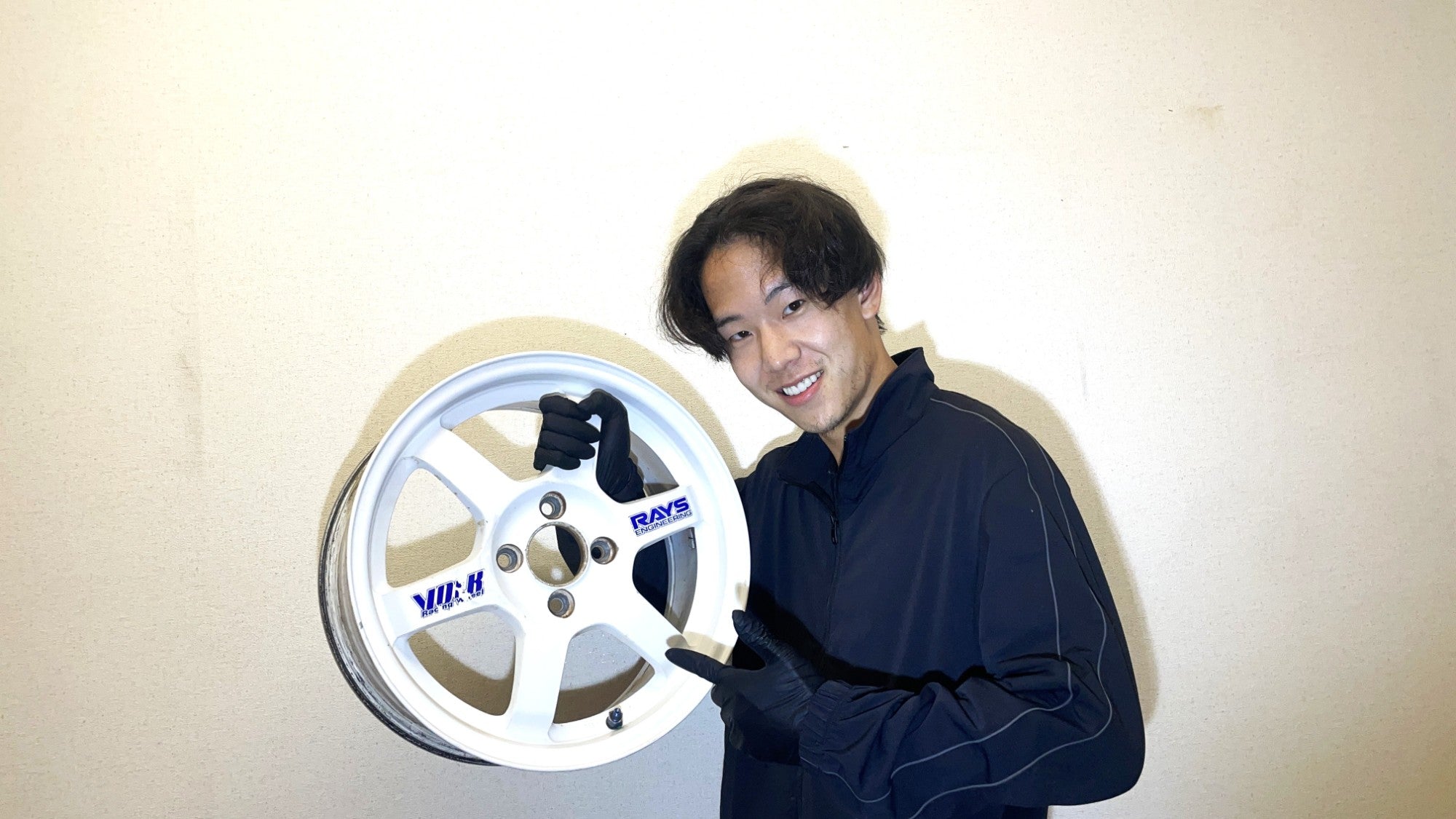 Akinari Uchiyama — OPUS JDM founder holding a RAYS Volk Racing wheel