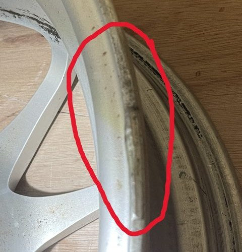 A weld mark left on the edge of the rim, circled in red
